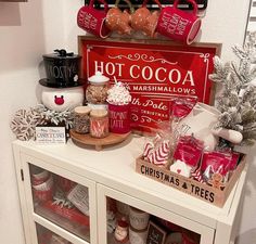 a christmas display with hot cocoa, marshmallows and other holiday treats on it