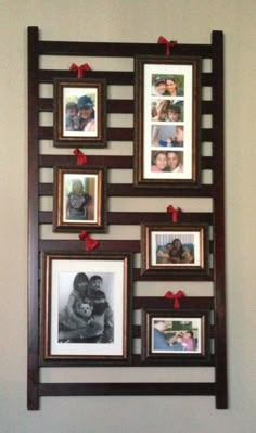 a wall hanging with pictures on it and red ribbon around the frame, which is decorated with hearts