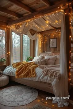 a bed with white sheets and lights on the headboard is in front of a window