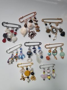 many different types of brooches on a white surface