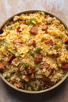 a close up of a bowl of food with rice and sausage on it, text reads cajun smoked sausage fried rice