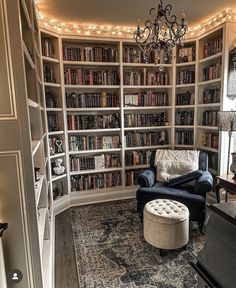 a living room filled with lots of bookshelves next to a couch and chair