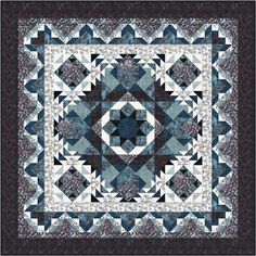 a blue and black quilt with an intricate design on it's center piece,