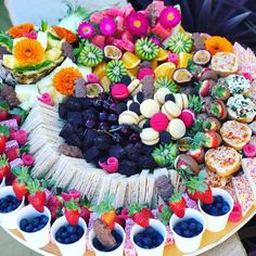 a platter filled with lots of different types of food on top of a table