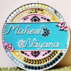 a colorful plate with the words mahesh naiyana written in white and blue