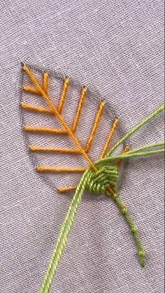 a close up of a piece of cloth with a plant on it's side