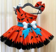 a dress made to look like a tiggera costume hanging on a clothes rack