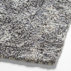 a gray and white rug on top of a floor