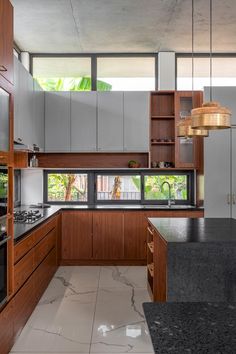 a kitchen with marble counter tops and wooden cabinets