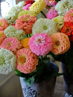 a vase filled with lots of different colored flowers