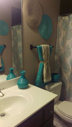 the bathroom is decorated in turquoise and brown