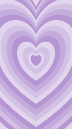 a heart shaped object in the middle of a purple and white striped wallpaper pattern