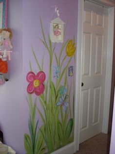 a child's room painted with flowers, butterflies and other things on the wall