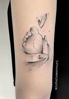 a woman's arm with a tattoo on it that has a heart in the middle