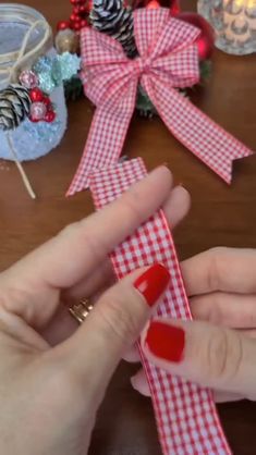 someone is making a red and white checkered ribbon