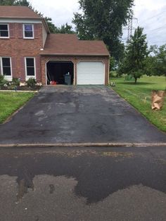 an empty driveway in front of a house