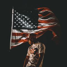 a man standing in front of an american flag