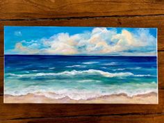 an oil painting of the ocean on a wooden table with wood planks in the background