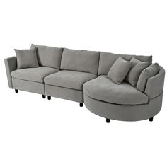 a large sectional couch with pillows on it's back and arms, sitting in front of a white background