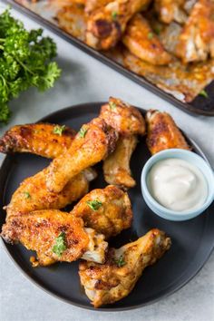 crispy oven baked chicken wings on a plate with ranch dressing