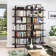 a living room filled with lots of books and furniture