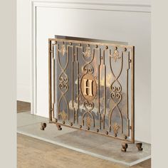 an ornate fireplace screen with the letter b on it