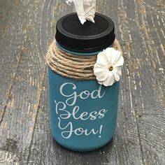 a blue mason jar with rope wrapped around it and a white flower on the lid