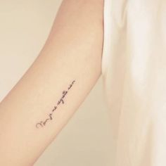 a woman's arm with the word love written in cursive writing on it