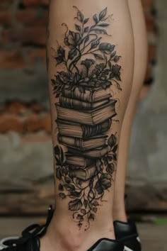 a woman's leg with books and flowers on it