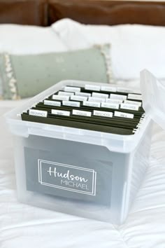 a bed with a large plastic box on top of it next to a pillow and pillows