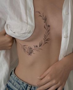 a woman's stomach with flowers and leaves on it