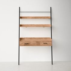 a wooden shelf with two drawers next to a white wall