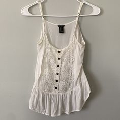 Like New! Beautiful Lace Detailing And Cute Buttons Dress Up This White Spaghetti Strap Tank Top From Forever 21. The Back Is Cropped, Whereas The Front Is Not, Giving This Top A Low-High Silhouette White Trendy Camisole For The Beach, Trendy White Camisole For The Beach, Trendy White Camisole For Beach, Trendy White Camisole For Day Out, White Summer Tank Top With Adjustable Straps, White Tops With Adjustable Straps For Vacation, Casual White Tank Top With Spaghetti Straps, White Trendy Camisole For Summer, White Spaghetti Strap Camisole Casual Style