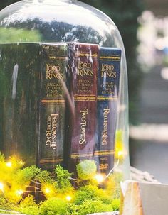 a glass cloche with some books under it