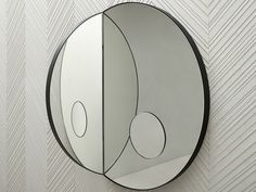 a circular mirror mounted to the side of a wall