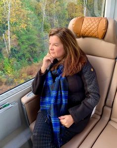 a woman sitting on a train looking out the window