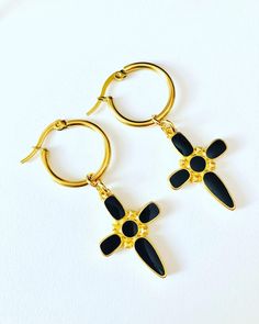 - Stainless steel hoop earrings , black cross earrings, the cross charm is 24K gold plated - The diameter of earrings is 2 cm (0,8 inches), charm length is 3.5 cm (1,4 inches) - Colors may appear slightly different on screen due to differences in resolution, brightness, and contrast JEWELRY CARE - Keep jewelry dry - Take it off before taking shower, bath, swimming or exercising - Makeup, perfume, hairspray apply before wearing jewelry - Store your jewelry somewhere dry, not in the bathroom Handm Gold Hoop Earrings With Black Enamel For Gift, Black Single Huggie Earring As A Gift, Black Enamel Hoop Earrings For Gift, Black Enamel Hoop Earrings As Gift, Black Huggie Hoop Earrings Gift, Black Stainless Steel Hoop Jewelry, Black Metal Cross Earrings, Black Stainless Steel Hoop Earrings As Gift, Black Cross Metal Earrings