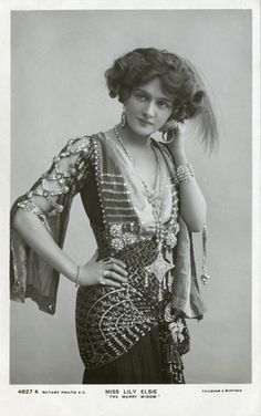 a black and white photo of a woman with her hair in a bun hairstyle