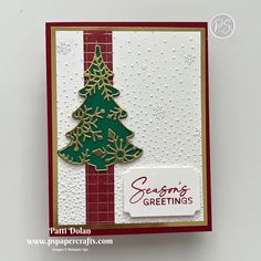 a handmade christmas card with a tree on the front and words seasons's greetings