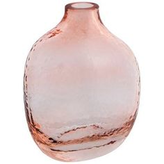 a pink glass vase sitting on top of a white table