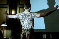 a man standing in front of a projection screen with his back turned to the camera