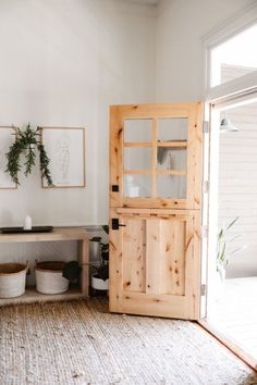 a room with a wooden door and some baskets on the floor in front of it