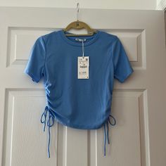 Never Worn Blue Stretch T-shirt For Summer, Blue Stretch Crew Neck Top, Fitted Blue T-shirt For Summer, Trendy Blue T-shirt For Spring, Basic Blue Summer Tops, Basic Blue Tops For Summer, Light Blue Fitted T-shirt For Summer, Blue Stretch Shirt For Summer, Fitted Light Blue T-shirt For Summer