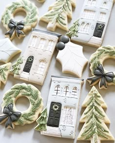 decorated cookies are arranged in the shape of houses