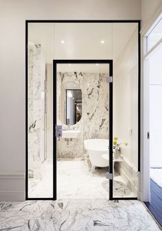 an elegant bathroom with marble floors and walls