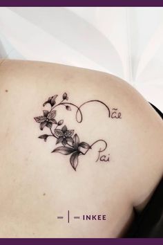 the back of a woman's shoulder with flowers and vines on her left side