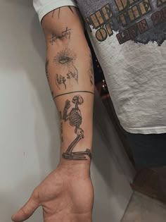 a man's arm with tattoos on it