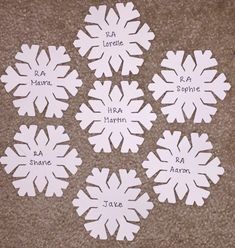 snowflakes with names on them sitting on the floor