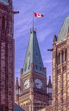 the canadian flag is flying high on top of an old building in ottawa, canada