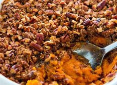 a bowl filled with sweet potato casserole topped with pecans